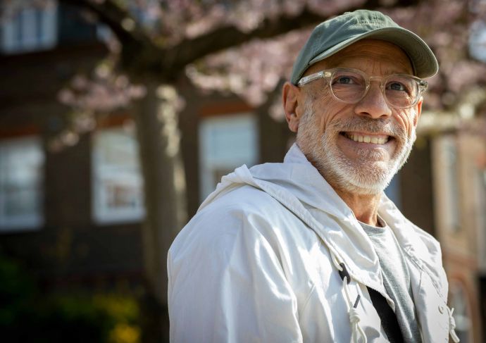 Older man wearing glasses and ball cap