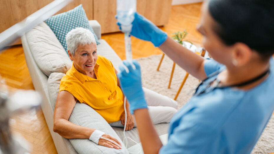 Patient receiving IV infusion therapy from a nurse