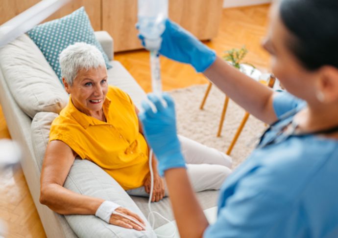 Patient receiving IV infusion therapy from a nurse