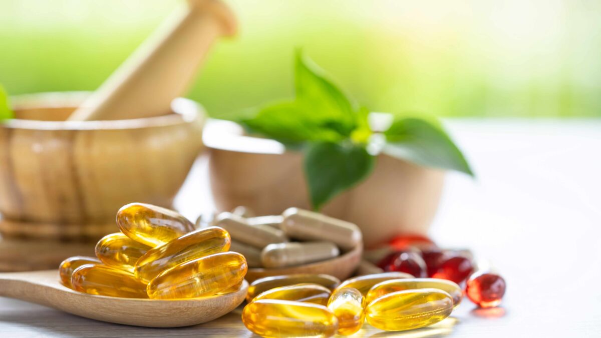 Vitamins and herbal supplements on table