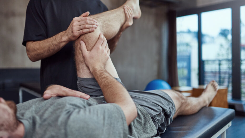 Athlete on a table getting their knee stretched
