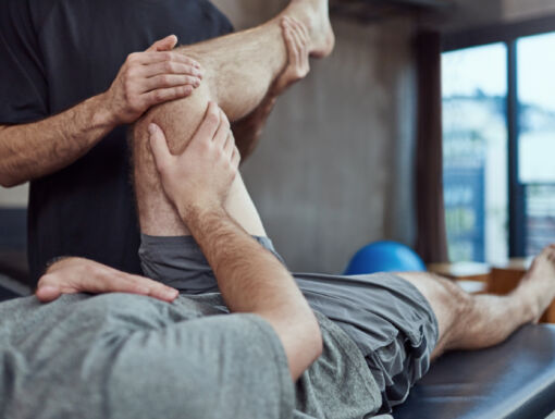 Athlete on a table getting their knee stretched