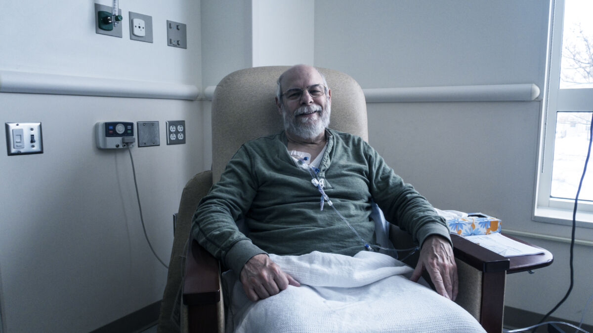 Man sitting in chair receiving chemotherapy