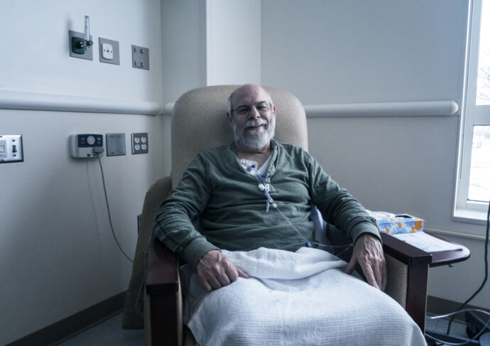 Man sitting in chair receiving chemotherapy