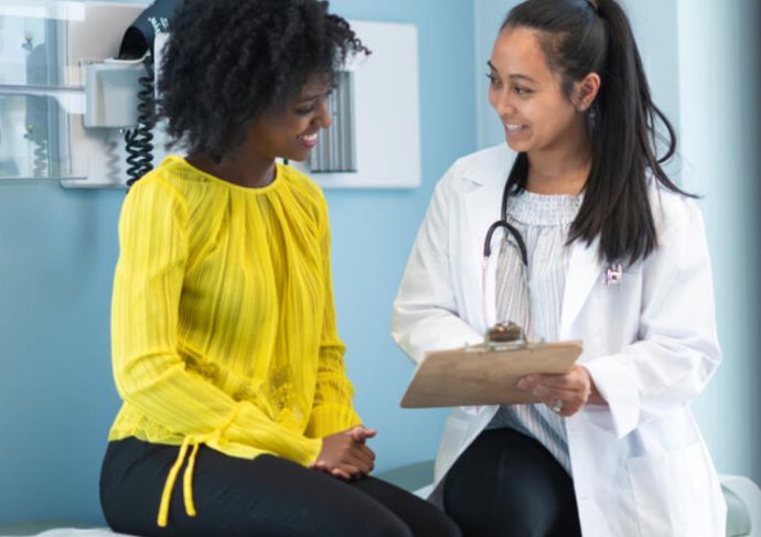 Woman speaking with doctor 1