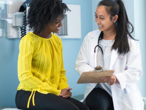 Woman speaking with doctor 1