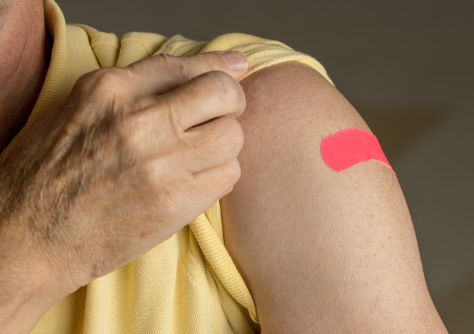 Arm with a Flu shot Band-Aid