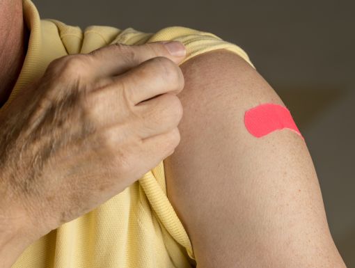 Arm with a Flu shot Band-Aid