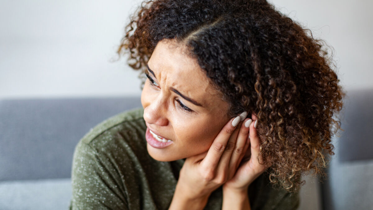 Woman having ear pain