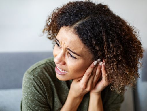 Woman having ear pain