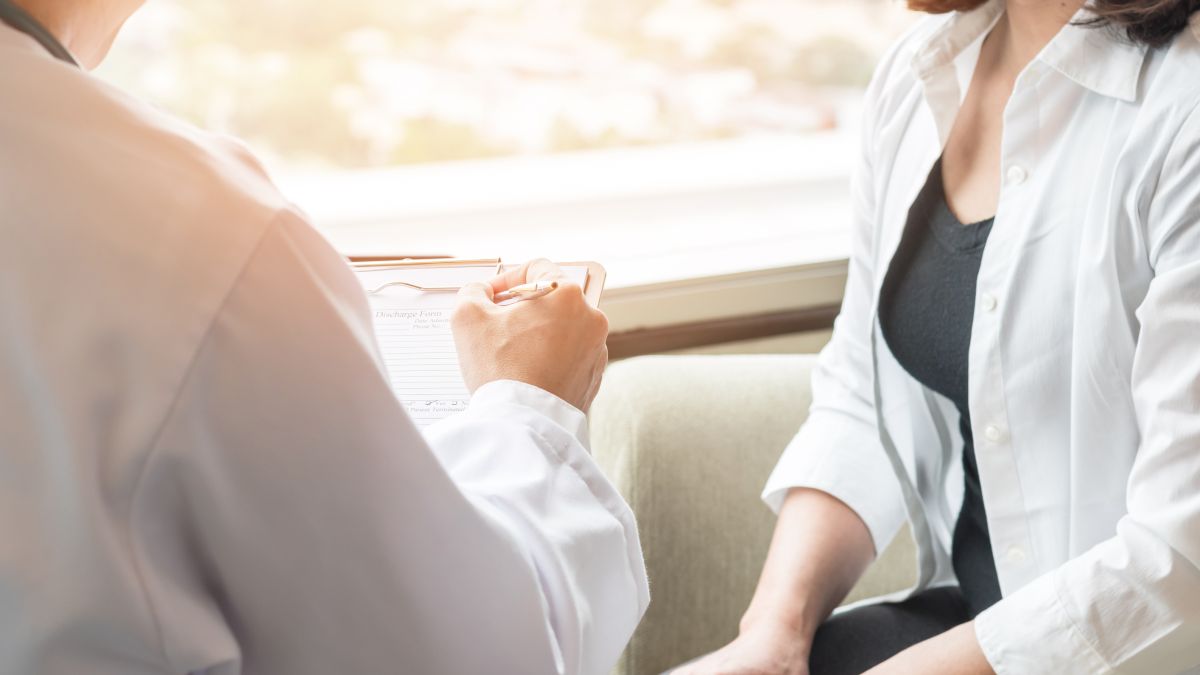 Doctor talking with female patient