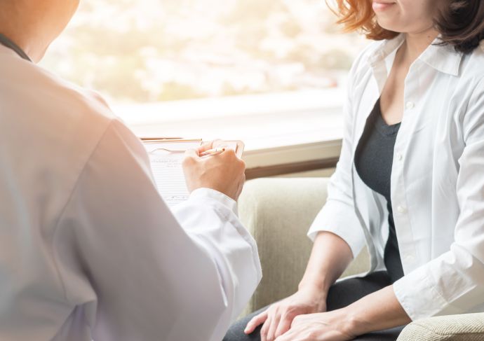 Doctor talking with female patient
