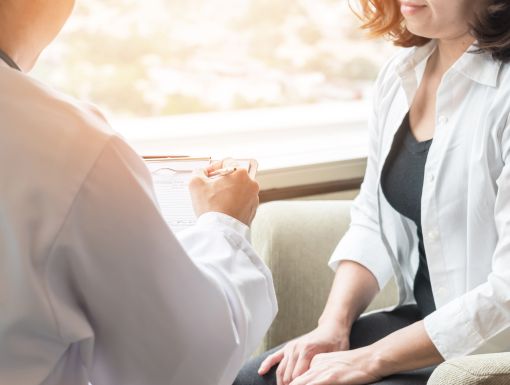Doctor talking with female patient