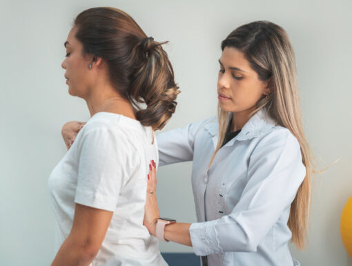 Woman standing while a doctor improves her posture