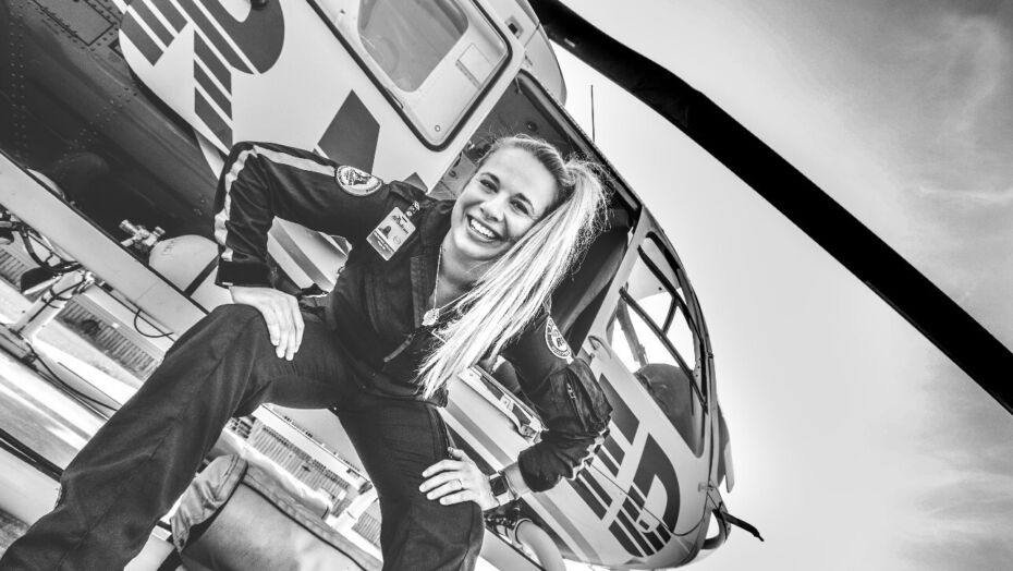 Mackenzie Johnson sitting outside helicopter