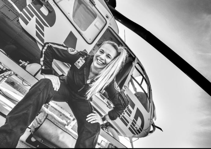 Mackenzie Johnson sitting outside helicopter