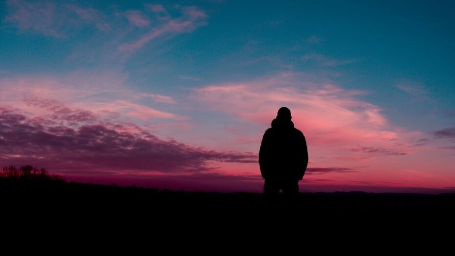 Man in outdoor solitude at sunset