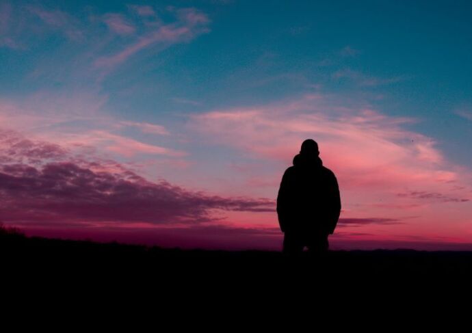 Man in outdoor solitude at sunset