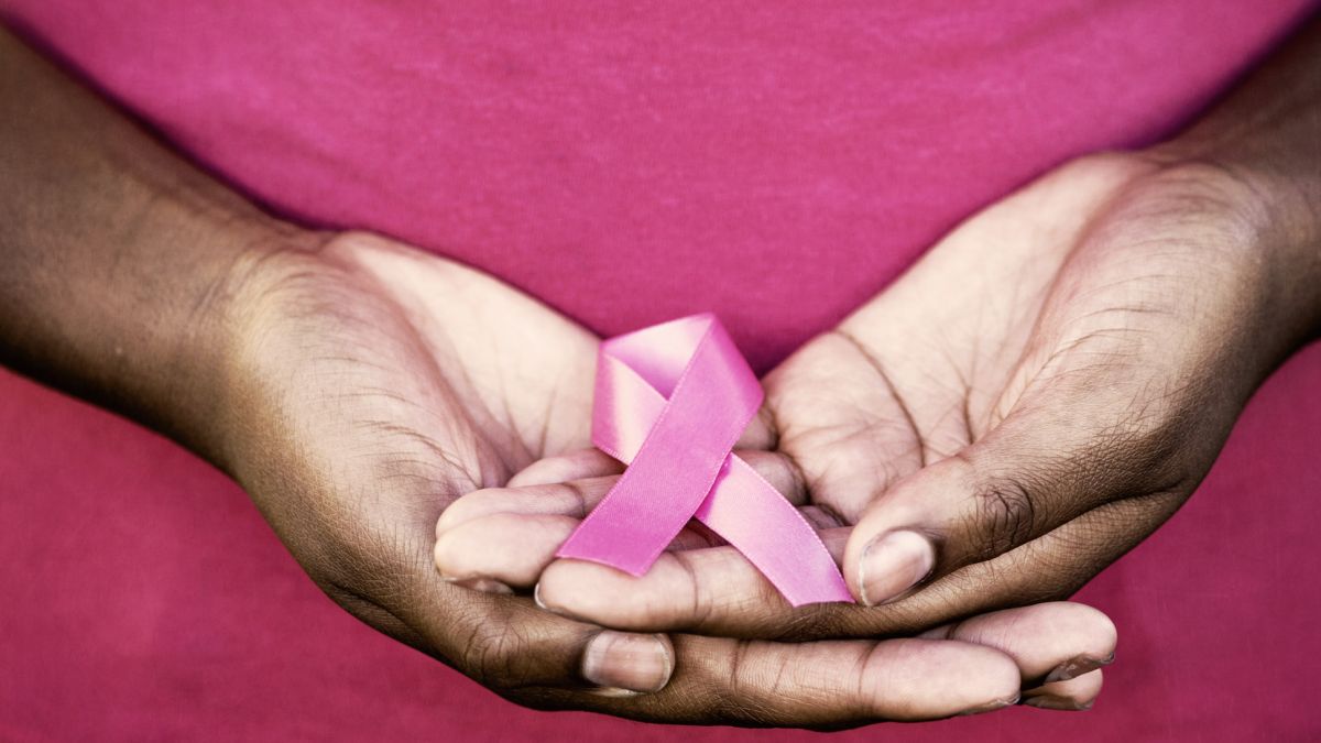 Woman holding breast cancer awareness ribbon