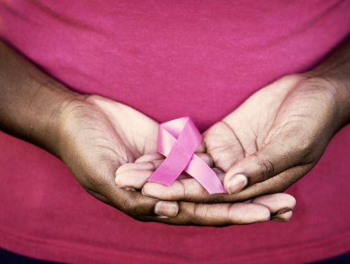 Woman holding breast cancer awareness ribbon