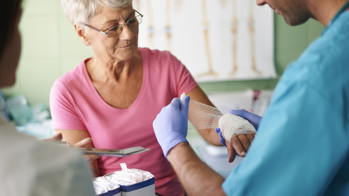Woman getting a wound on her hand dressed