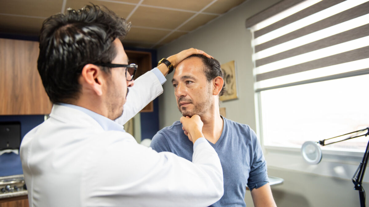 Neurosurgeon attending to male patient