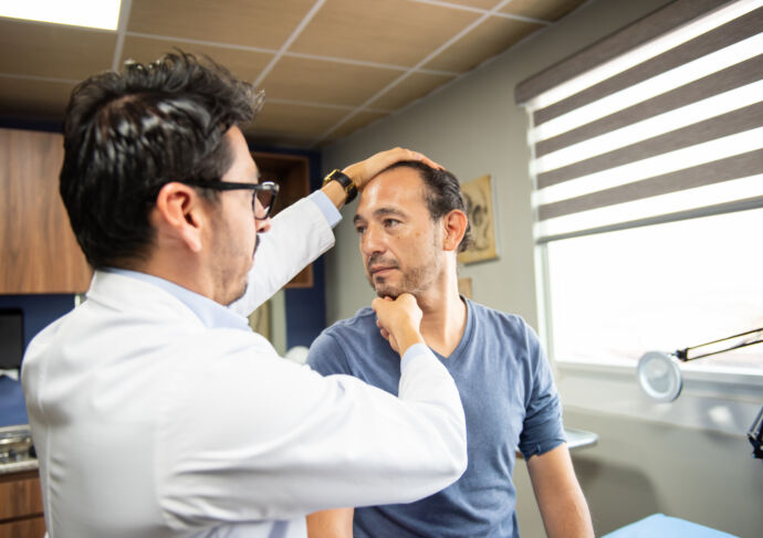 Neurosurgeon attending to male patient