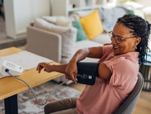 Mature woman taking her blood pressure at home