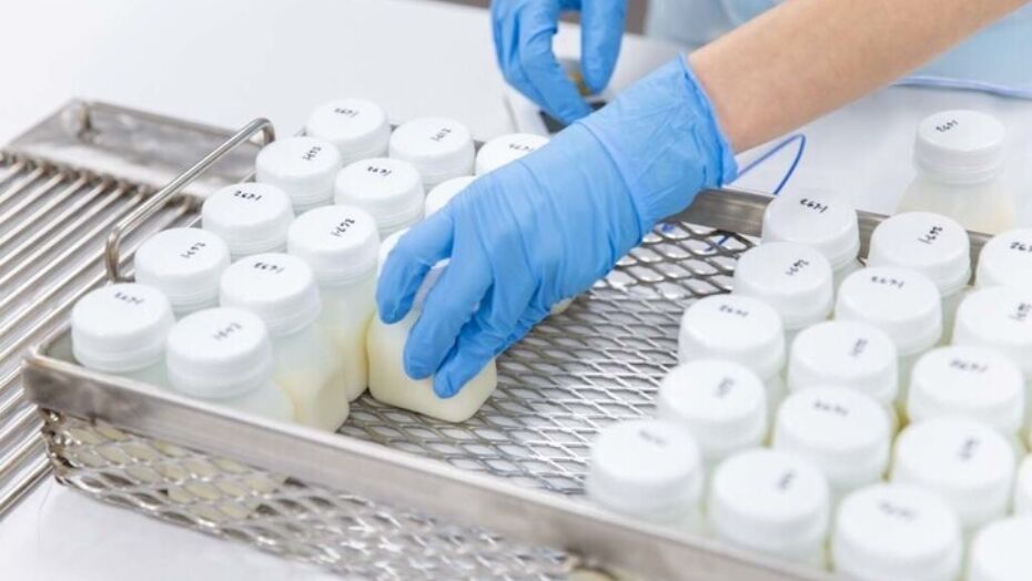 Small bottles of breastmilk being stored in freezer