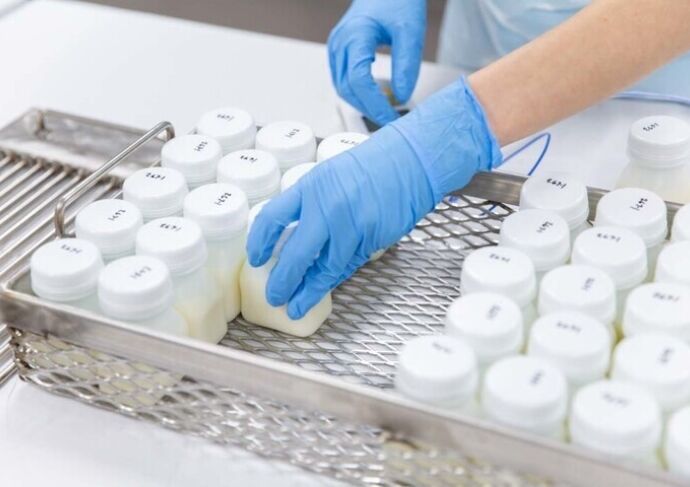 Small bottles of breastmilk being stored in freezer