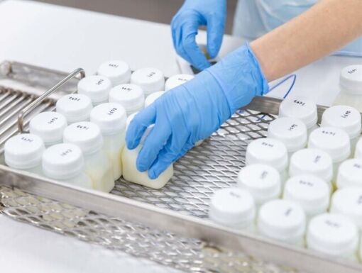 Small bottles of breastmilk being stored in freezer