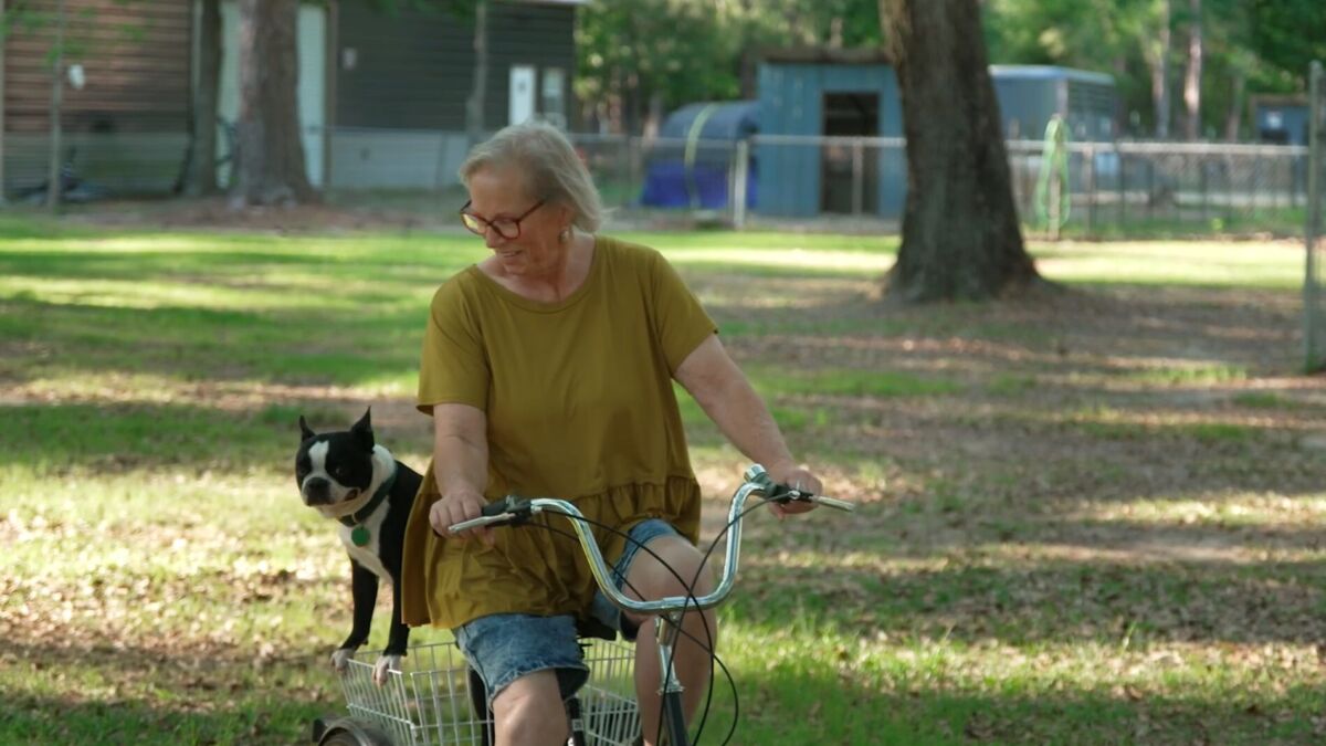 Diabetic woman riding tricycle with dog