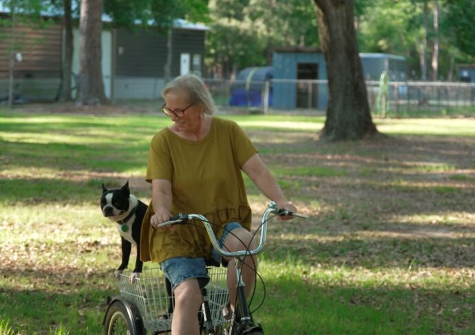 Diabetic woman riding tricycle with dog