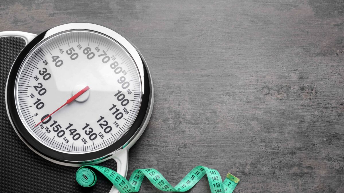 Scale with measuring tape strewn on floor