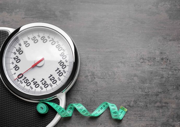 Scale with measuring tape strewn on floor