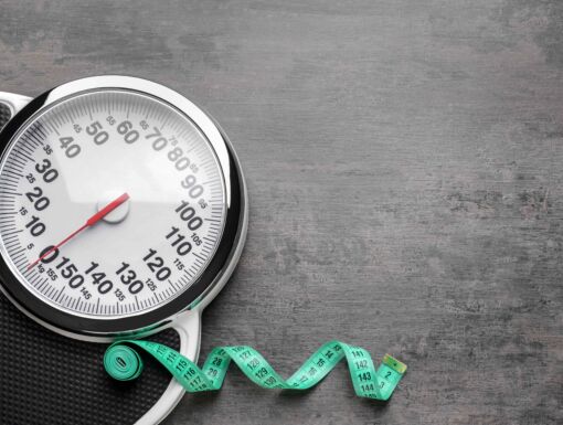 Scale with measuring tape strewn on floor