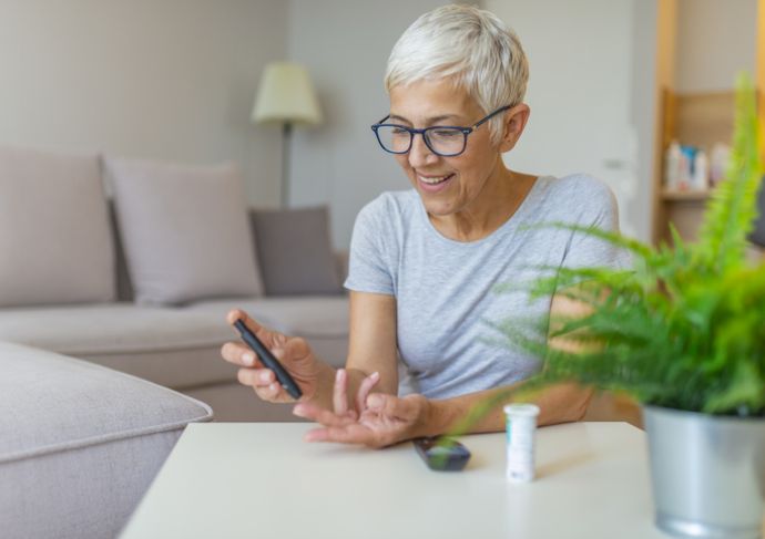 Woman checking her blood sugar reading