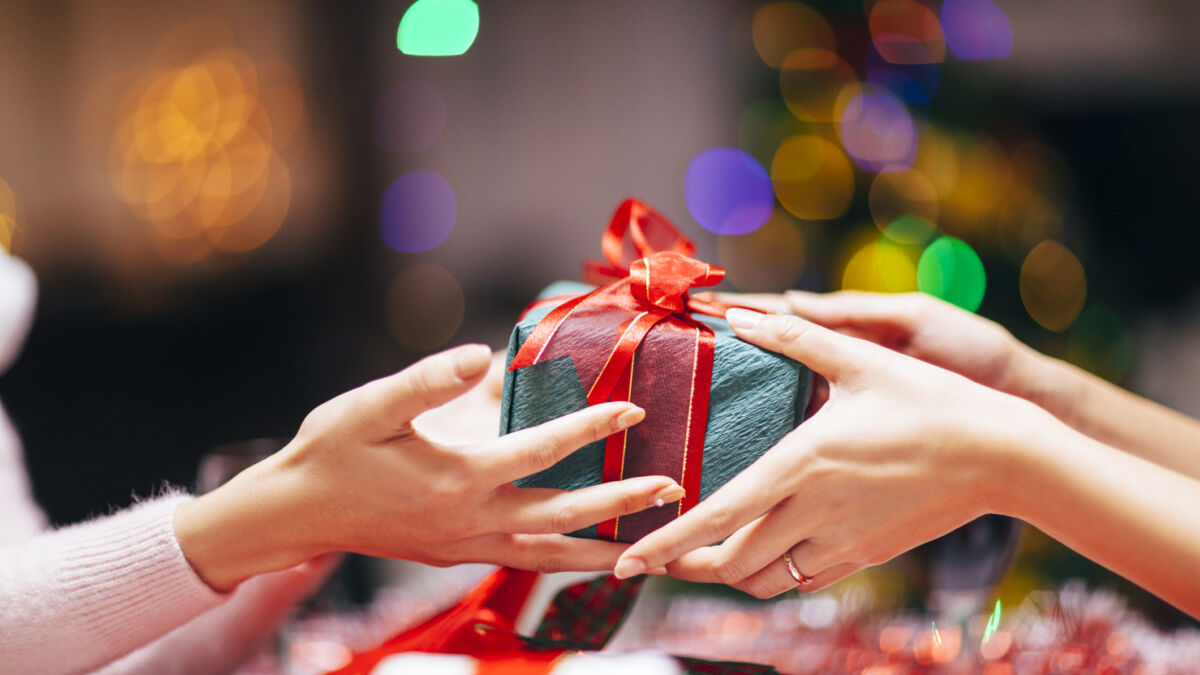 Hands giving holiday gift