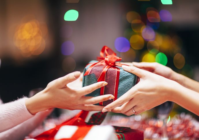 Hands giving holiday gift