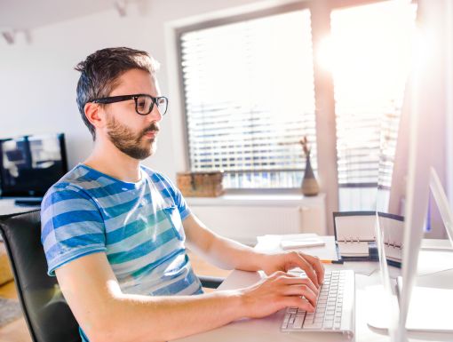 Man with glasses at computer