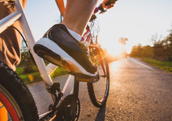 image of feet on bike pedals while riding outdoors