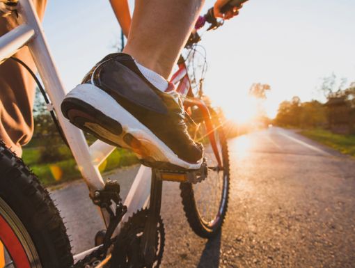 image of feet on bike pedals while riding outdoors