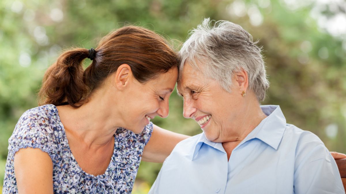 Younger woman with her mom who has Alzheimer's disease
