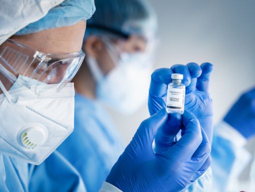 Doctor looking at vaccine