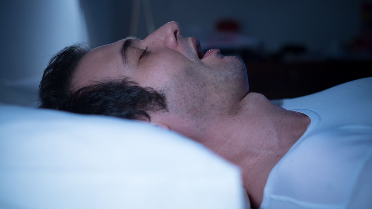 Man sleeping with sleep apnea