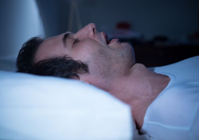 Man sleeping with sleep apnea