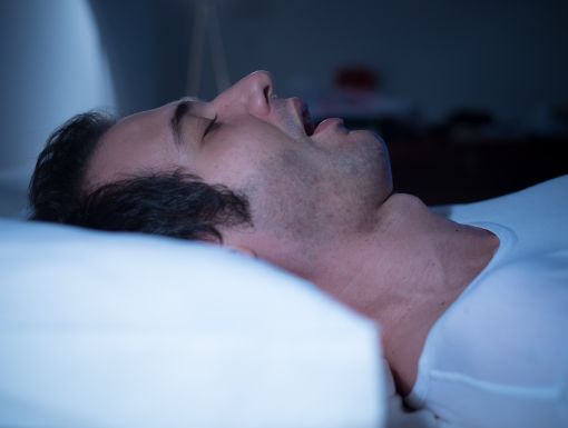 Man sleeping with sleep apnea