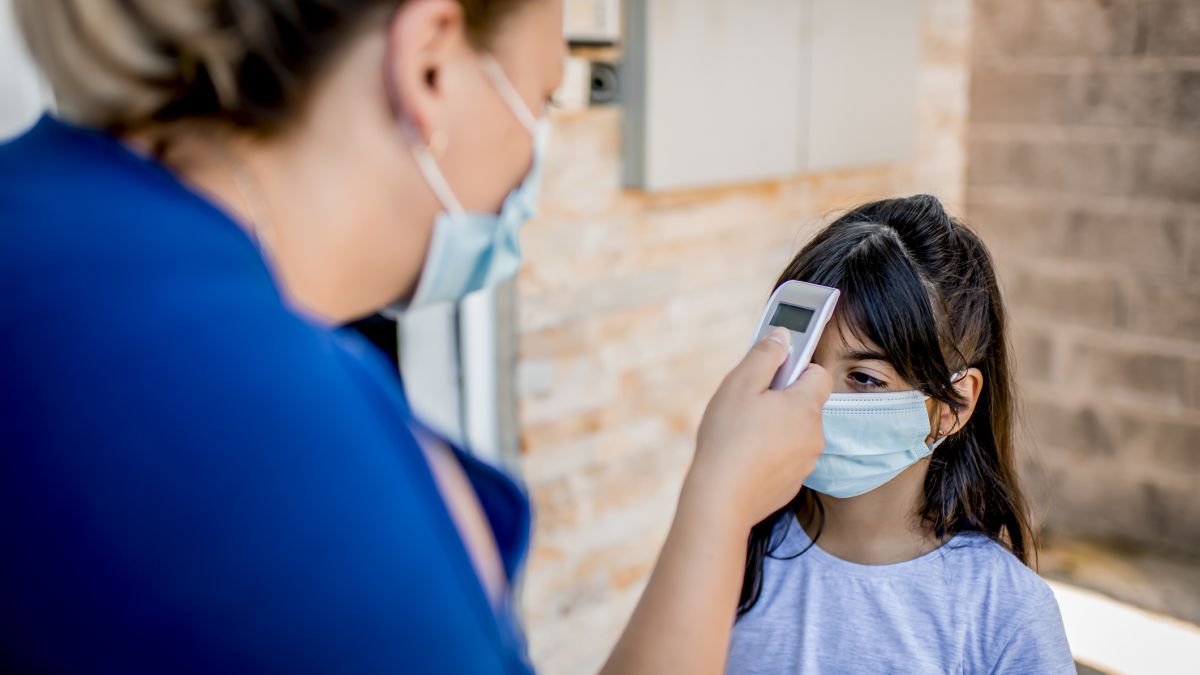 School nurse checking temp