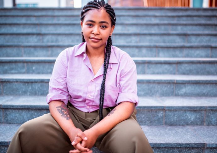 Women with heart disease sitting on steps outside.