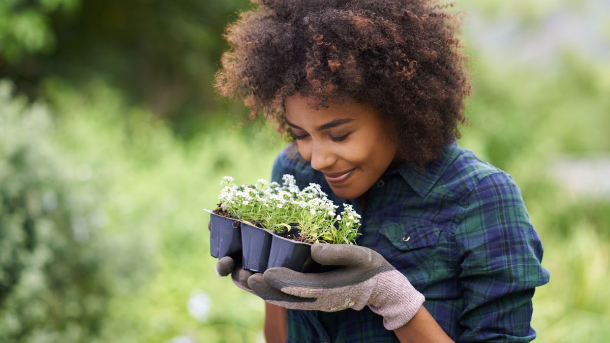 Woman smelling plants in garden